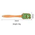 Green Christmas silicone spatula with wooden handle featuring festive tree and gingerbread motifs - Green Print Merry Christmas