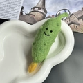 Handmade wool felt pickle keychain with smiling face in a white heart-shaped tray - Pickle Cucumber
