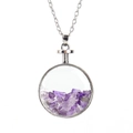 Detailed macro view of the silver chain and round glass pendant filled with purple crystals - Silver + Amethyst