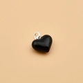 Polished 925 sterling silver heart pendant with black enamel finish on beige background - Black