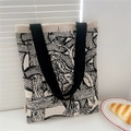 Detail view of large knit tote bag with artistic patterns and secure metal buckle closure - Woven Rope