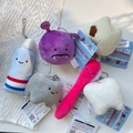 Collection of six cute plush tooth-themed keychains on white honeycomb paper - White Tooth