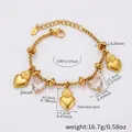 Detail shot of golden snake chain bracelet with heart pendants and zircon stones - Gold Heart Multi-Charm Bracelet / 15+4cm / Gold