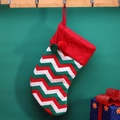 Knitted Christmas stocking with red, green and white zigzag pattern and colorful pom-poms - Green Stripe Sock