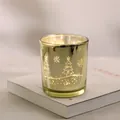 Detail of a gold plated Christmas candle holder with star and tree patterns - Gold Christmas Tree Snowflake