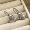 Sliver hollow heart drop earrings with zircon embellishments on beige velvet - Silver