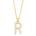 Close-up of golden letter R necklace pendant inlaid with elegant white pearls - Letter R