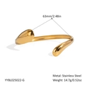 Close-up of polished 18K gold-plated stainless steel wave bangle with 63mm diameter - Gold