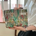 Detail of floral canvas makeup bag with woven fabric texture and original side label - Swirl Flower