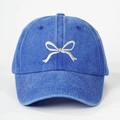Close-up of bow embroidery detail on washed denim blue baseball cap with high texture - One Size / Royal Blue