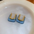 Detailed close-up of vintage U-shaped earrings with gold metal and deep blue resin - U-Shaped Bag Ear Buckle / Blue