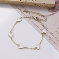 Detail of gold chain bracelet with five white enamel hearts and lobster clasp closure - Cream Heart Enamel Bracelet (0428-1 Cream)