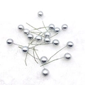 Close-up of shiny silver artificial berry ornaments on a white plush background - 15mm / Silver