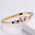 Golden open bangle with snake-shaped wave design set with pink and white rhinestones - Gold