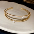 Double-layered gold open bracelet with sparkling zircons and white pearls in French style - Double Layer Cuff Bracelet / Gold