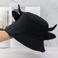 Detail shot of a black bucket hat featuring playful devil horns on the top part - Pure Black