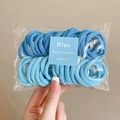 Detailed macro view of high-elasticity blue hair ties in transparent packaging bag - Blue Series 50Pcs