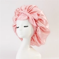 Close-up of pink satin hair bonnet with large bow and soft pleated edge details - Medium Single Layer Ribbon / Nude Pink