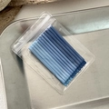 Close-up of blue gradient metal hairpins packaged in a clear zipper bag on a tray - Dark Blue