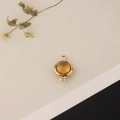 Detailed close-up of a double-loop round amber crystal connector in gold-plated setting - 1 Piece / Yellow