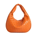 Orange hand-woven leather hobo bag with a minimalist shoulder strap on white background - Orange