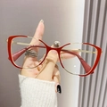 Cat eye glasses frame in red and gold metal finish shown held by hand - Red Gold Frame