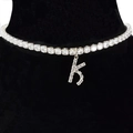 Silver letter K necklace with sparkling zircon pavé on a black velvet display - Letter K [Silver]