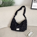 Detail of black corduroy crossbody bag with silver bow and heart prints on textured fabric - Black