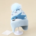 Detail of light blue baby knit earflap hat with shark pattern and large faux fur pom-pom - 3-8 Years / Blue