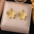 Detailed macro view of golden floral stud earrings displayed on a textured jewelry gift box - Flower Stamen Studs(AG490) / Gold