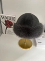 Deep grey faux fur winter bucket hat with thick plush texture on a gold metal stand - Dark Gray