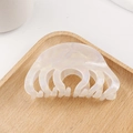 Pearlescent white acetate hair claw clip with shell texture on a wooden tray - Snow White (Pearlescent White)