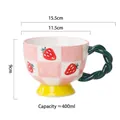 Ceramic mug featuring strawberry checkerboard pattern and green twisted handle - Strawberry Checkerboard
