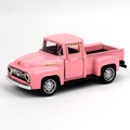 Detailed close-up of a pink vintage alloy Ford pickup truck model with silver accents - Pink