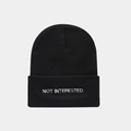 Close-up of black knit beanie featuring white NOT INTERESTED embroidered slogan on cuff - NOT Slogan Embroidery / Black