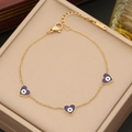 Golden chain bracelet with purple heart charms and evil eye details in a jewelry box - Sapphire Blue