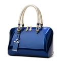 Dark blue patent leather handbag with woven handle and polished gold metal buckles - Blue