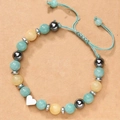 Detail of handmade adjustable beaded bracelet with heart charm and magnetic stones. - Braided Green Style