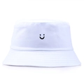 Minimalist white cotton bucket hat with a black embroidered smiley face on a plain background - One Size (56-58cm) Non-adjustable / White