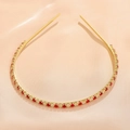 Close-up of golden metal headband with red and clear square crystals on silk fabric - Red White Gold (FG0009-1)