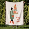 Detail of Christmas throw blanket with festive cartoon print and colorful fringe edges - Christmas Advent Calendar