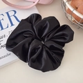 Oversized black satin scrunchie with silky luster and soft pleats for elegant hairstyles - Glossy Black