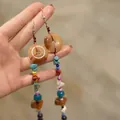 Detail of ethnic earrings with orange resin disks and multi-colored beaded tassels - Colorful Round Wood Bead Ear Hook (11#)