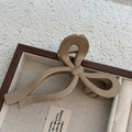 Detail of khaki brown bow hair claw clip with 'Only Belong To You' text on jewelry tray - Glossy Coffee Bow Claw