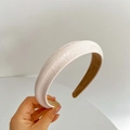 Close-up of textured cream faux leather padded headband with beige inner lining - Beige