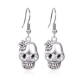 Silver skull earrings with flower detail and ear hooks for Halloween, set on white background - 8.Silver Skull Earrings