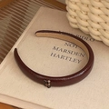 Minimalist burgundy red PU leather headband with retro texture on vintage book - Dark Red