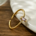 Detail of gold-plated open ring featuring a rectangular purple zircon stone setting - Adjustable Open / Purple Zirconia