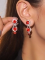 Sparkling red crystal tassel earrings with silver base on model, elegant jewelry gift - Three-tier Red Gemstone Earrings