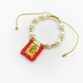 Detailed view of handmade religious bracelet with white pearls and Guadalupe pendant. - Red